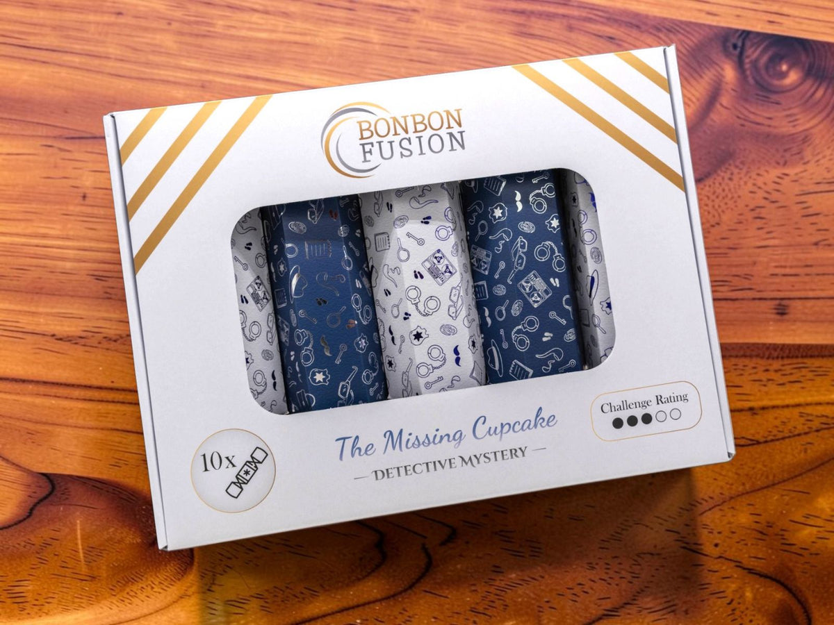 A boxed set of four rolled mystery items from Bonbon Fusion, titled 'The Missing Cupcake - Detective Mystery'. The white box features gold stripes and a clear window showing the patterned rolls inside.